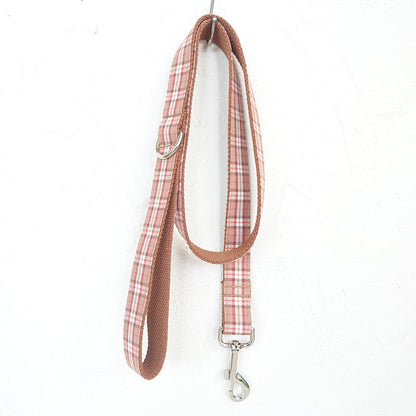 Plaid dog leash with metal clip on a white background