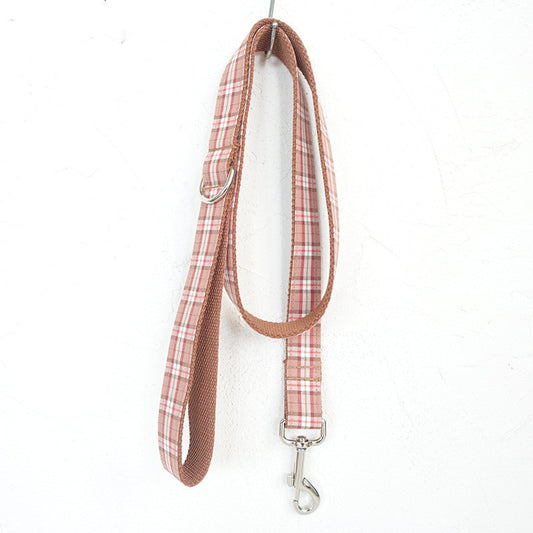 Plaid dog leash with metal clip on a white background