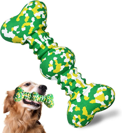 Dog playing with a green and yellow bone-shaped toy on a white background